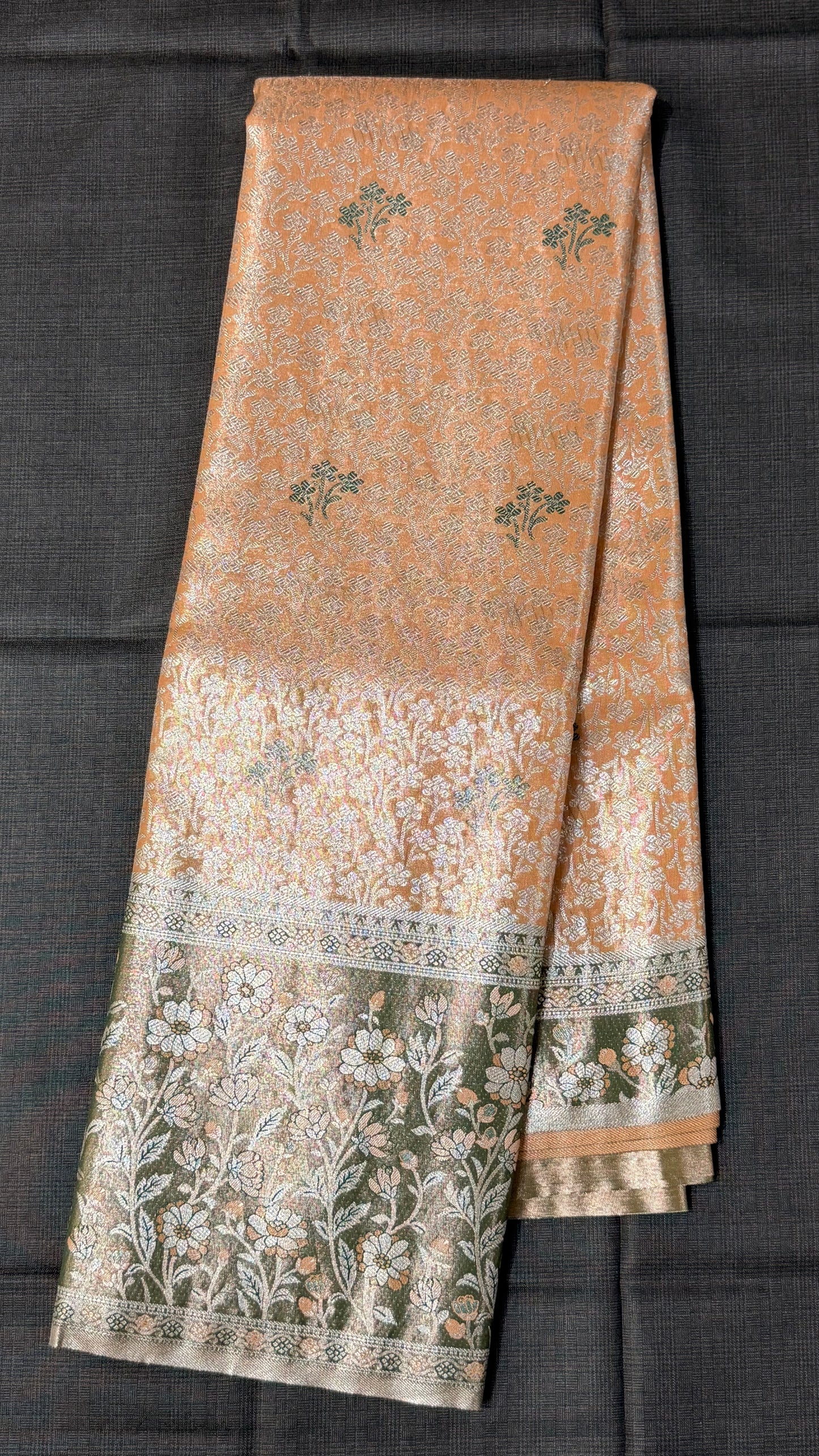 Orange floral Semi Kanchipattu sarees with traditional Meenakari border