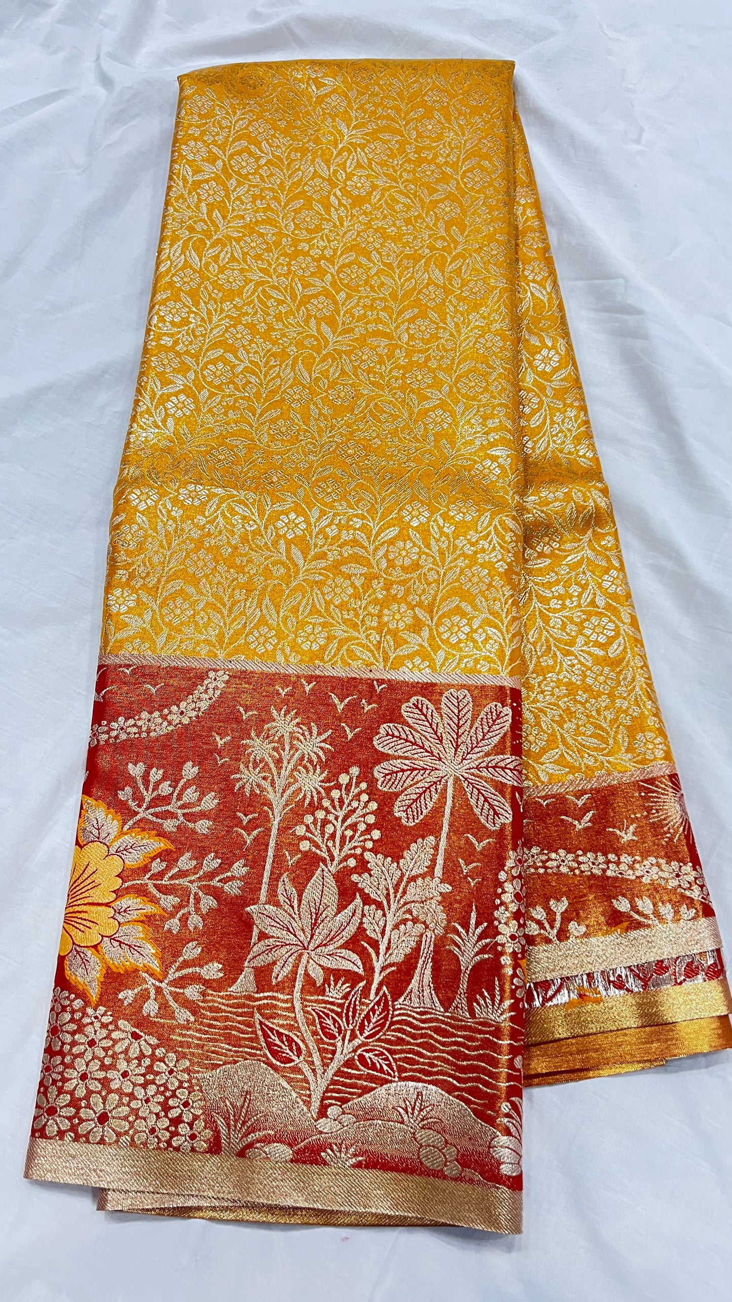 Yellow Semi Kanchipattu sarees with orange traditional Meenakari border