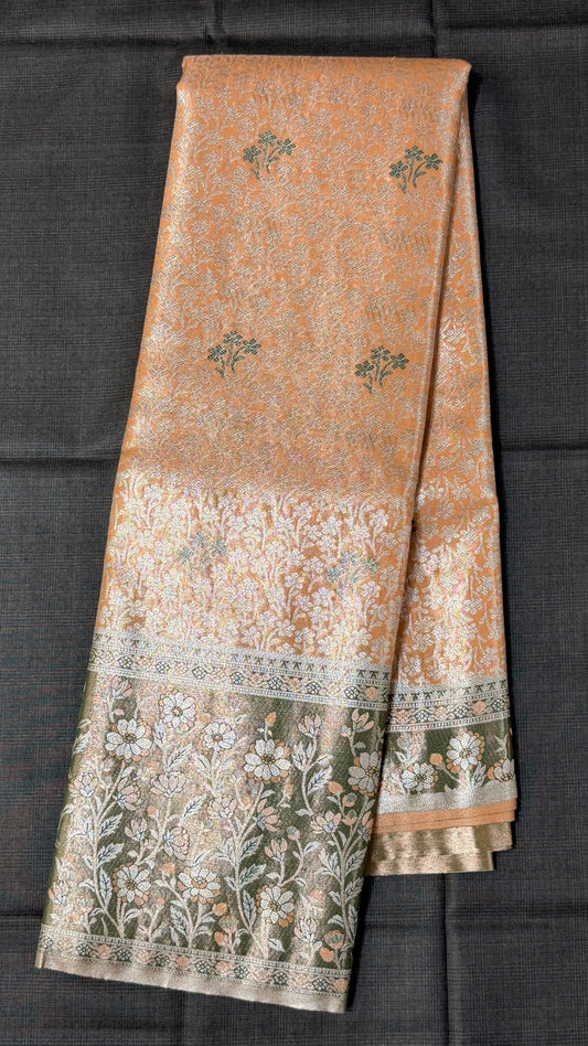 Orange floral Semi Kanchipattu sarees with traditional Meenakari border