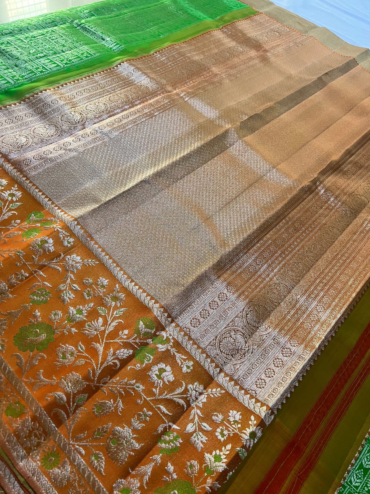 Premium Parrot Green Kanchipattu Saree with Orange Meenakari Border & Silver Zari Detailing
